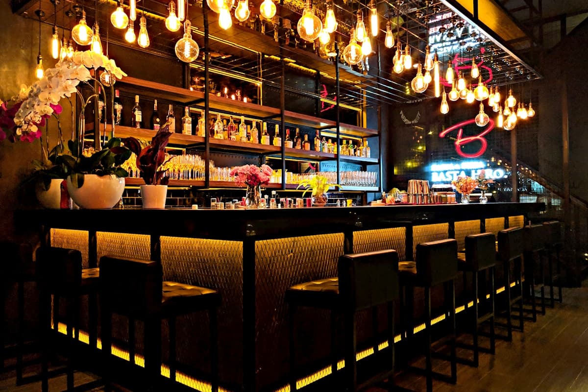 Illustrative warmly lit bar and dining room